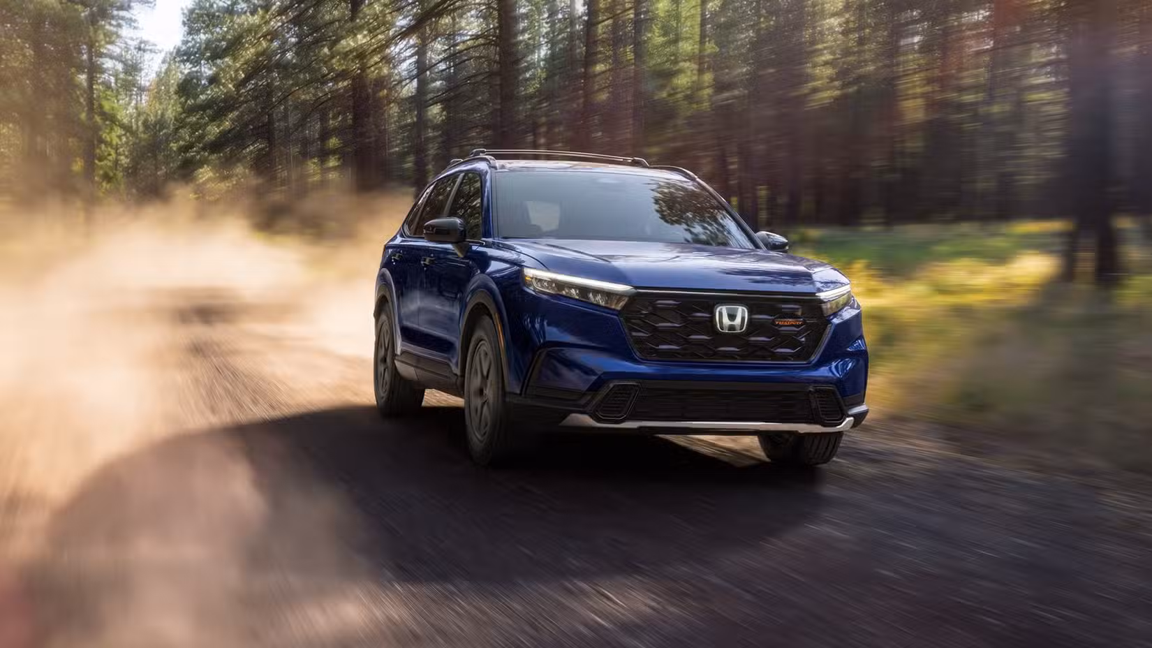 Dynamic front 3/4 shot of a blue 2025–2026 Honda- CR-V TrailSport Hybrid.