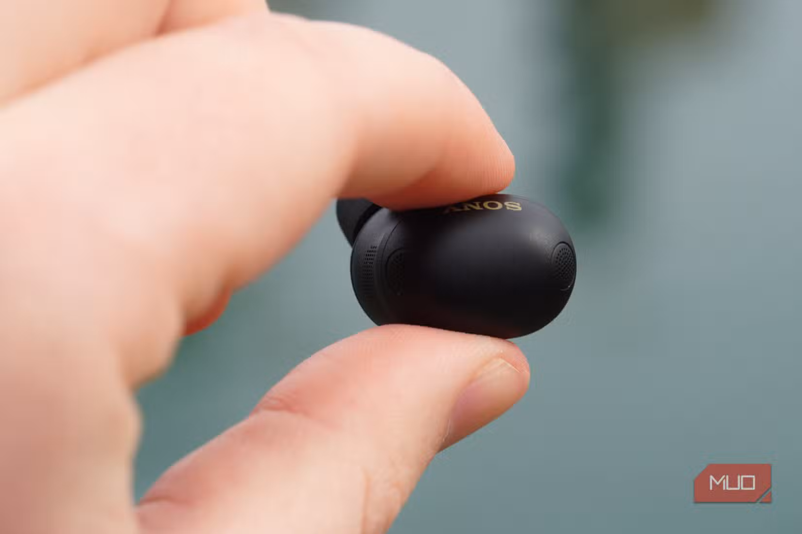The Sony WF-1000XM6 earbuds in the hand.