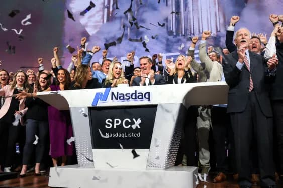 Bret Johnsen (C), SpaceX Chief Financial Officer, and Gwynne Shotwell (center R), SpaceX President and Chief Operating Officer, celebrate as they ring the opening bell at the Nasdaq MarketSite to celebrate the launch of SpaceX’s initial public offering (IPO) in New York on June 12, 2026.