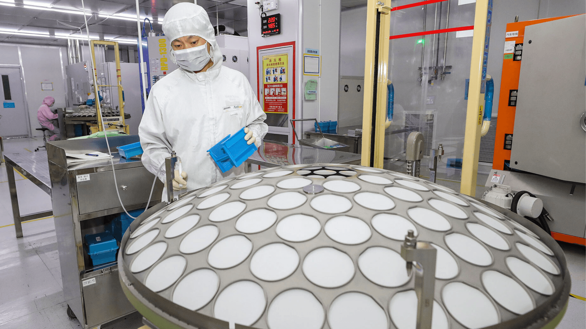 A worker produces chips for mobile phones, cars, LED lighting at a workshop in Huai 'an city.