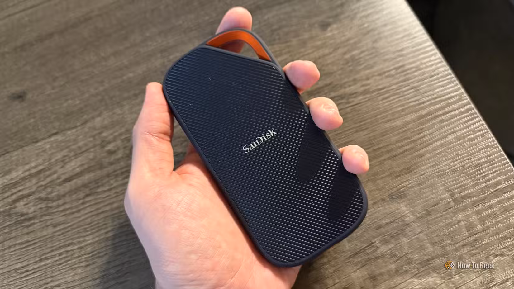 A hand holds the SanDisk Extreme PRO Portable SSD with USB4.