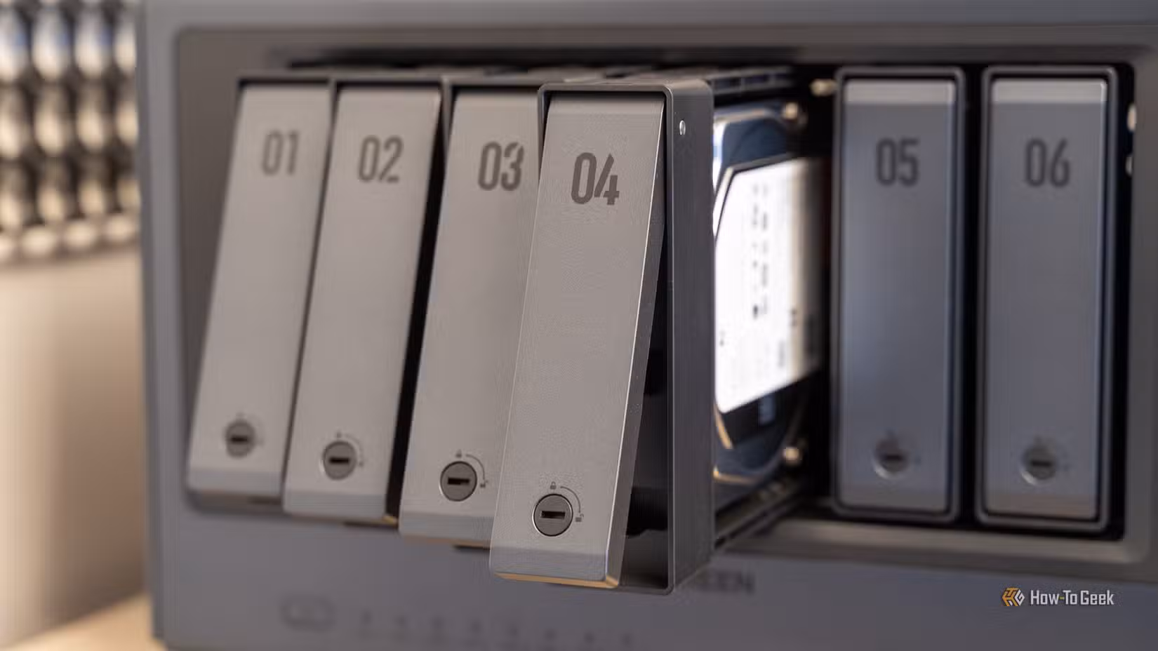 The UGREEN iDX6011 Pro NAS with drives pulled out of it.