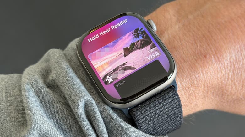 Closeup of an Apple Watch, ready for a contactless payment, on a person