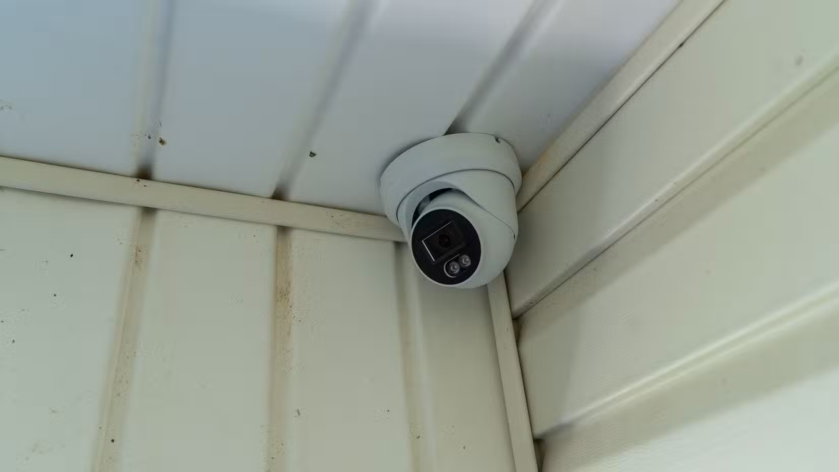 A PoE security camera mounted in the corner of a porch.