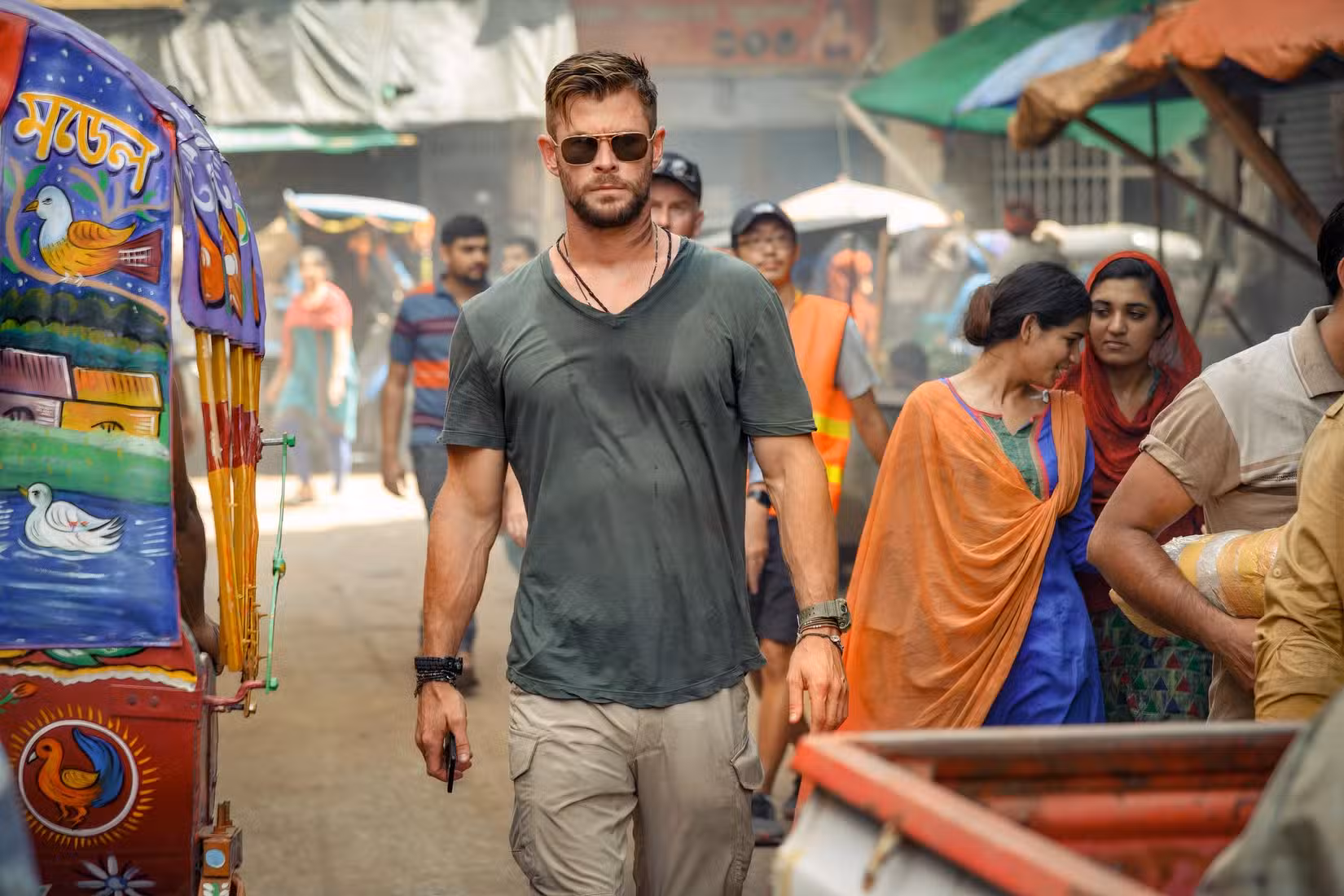 Chris Hemsworth walks down the road in Extraction.