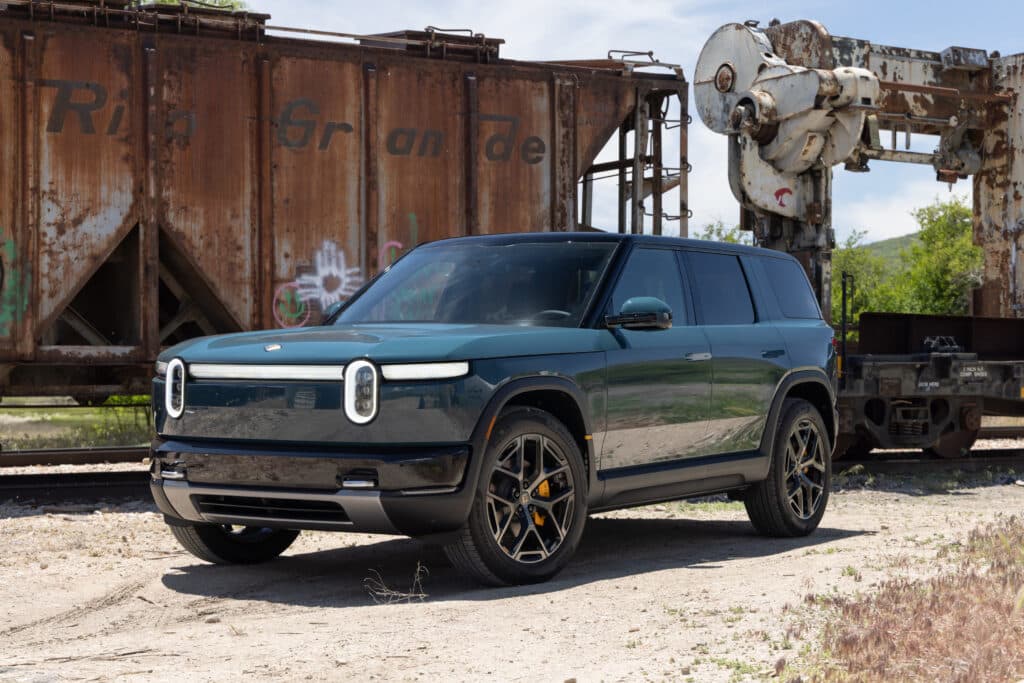 A green Rivian R2 seen from the front 3/4s
