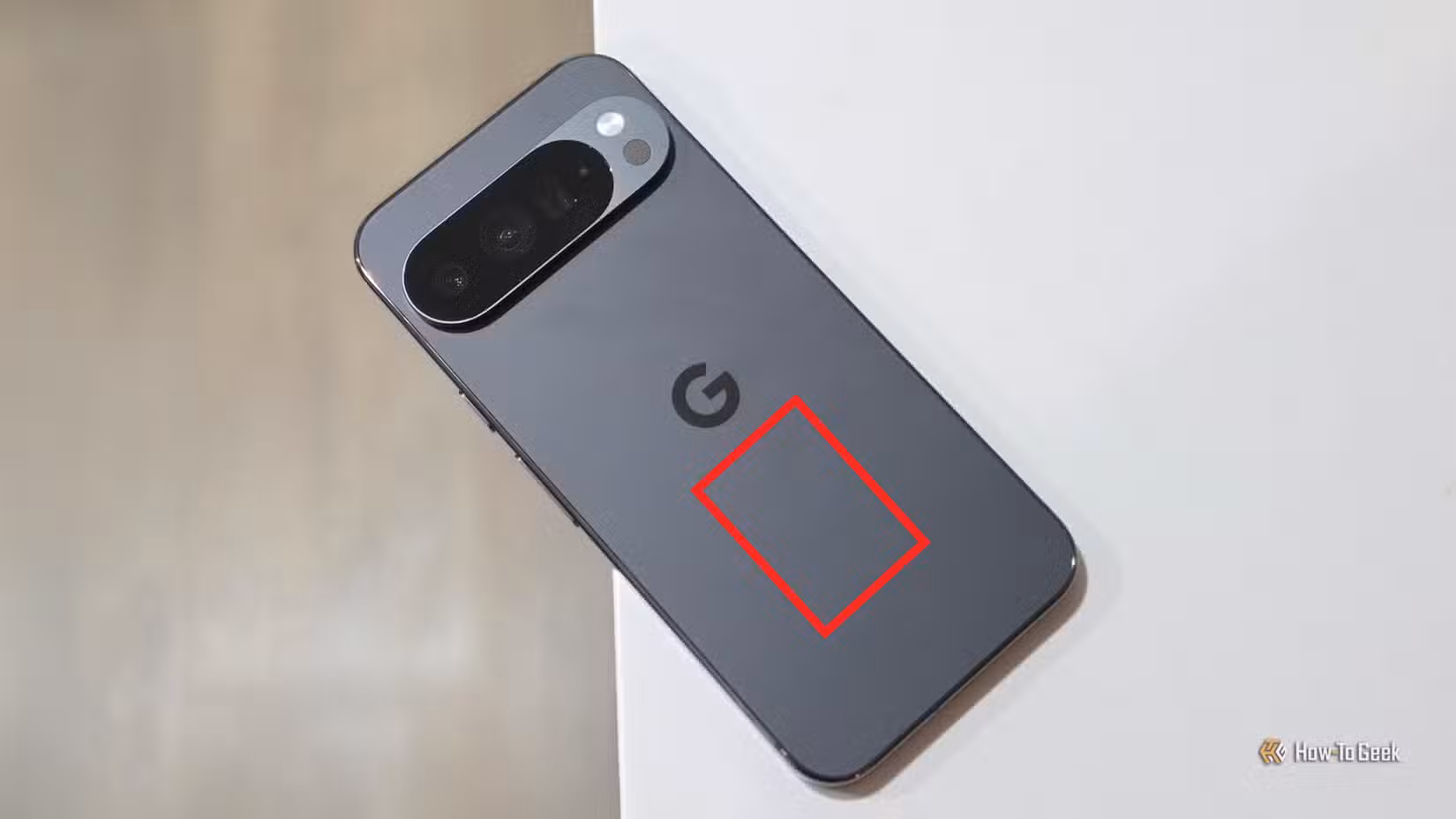 A Pixel 10 Pro with a highlighted square showing the optimal area to activate Quick Tap.