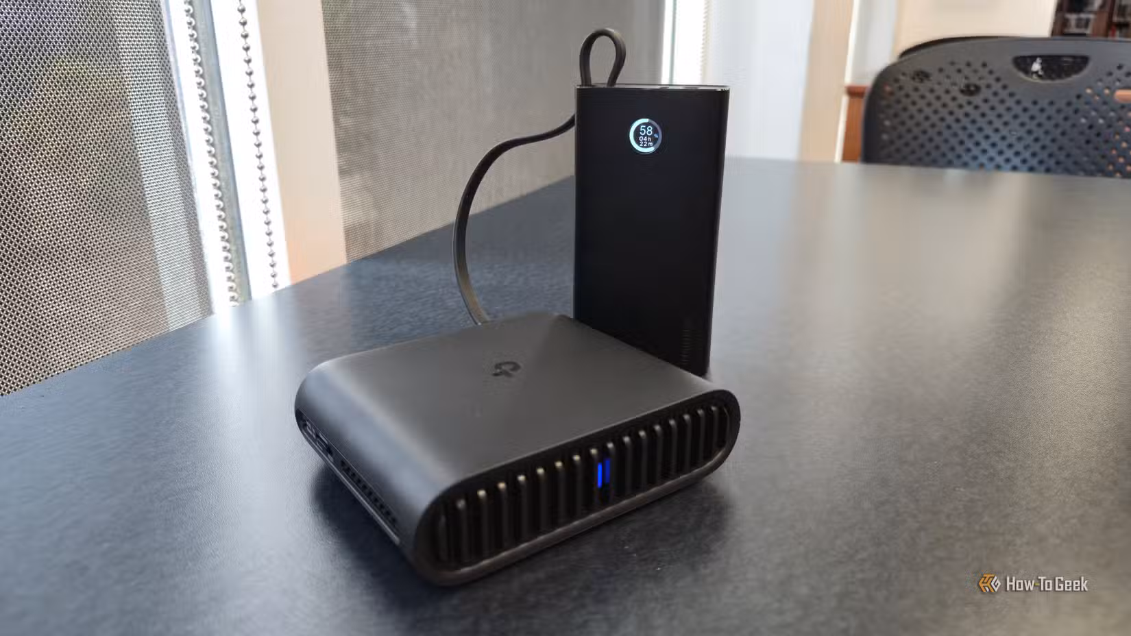 TP-Link AX3000 travel router charging from a portable battery bank.
