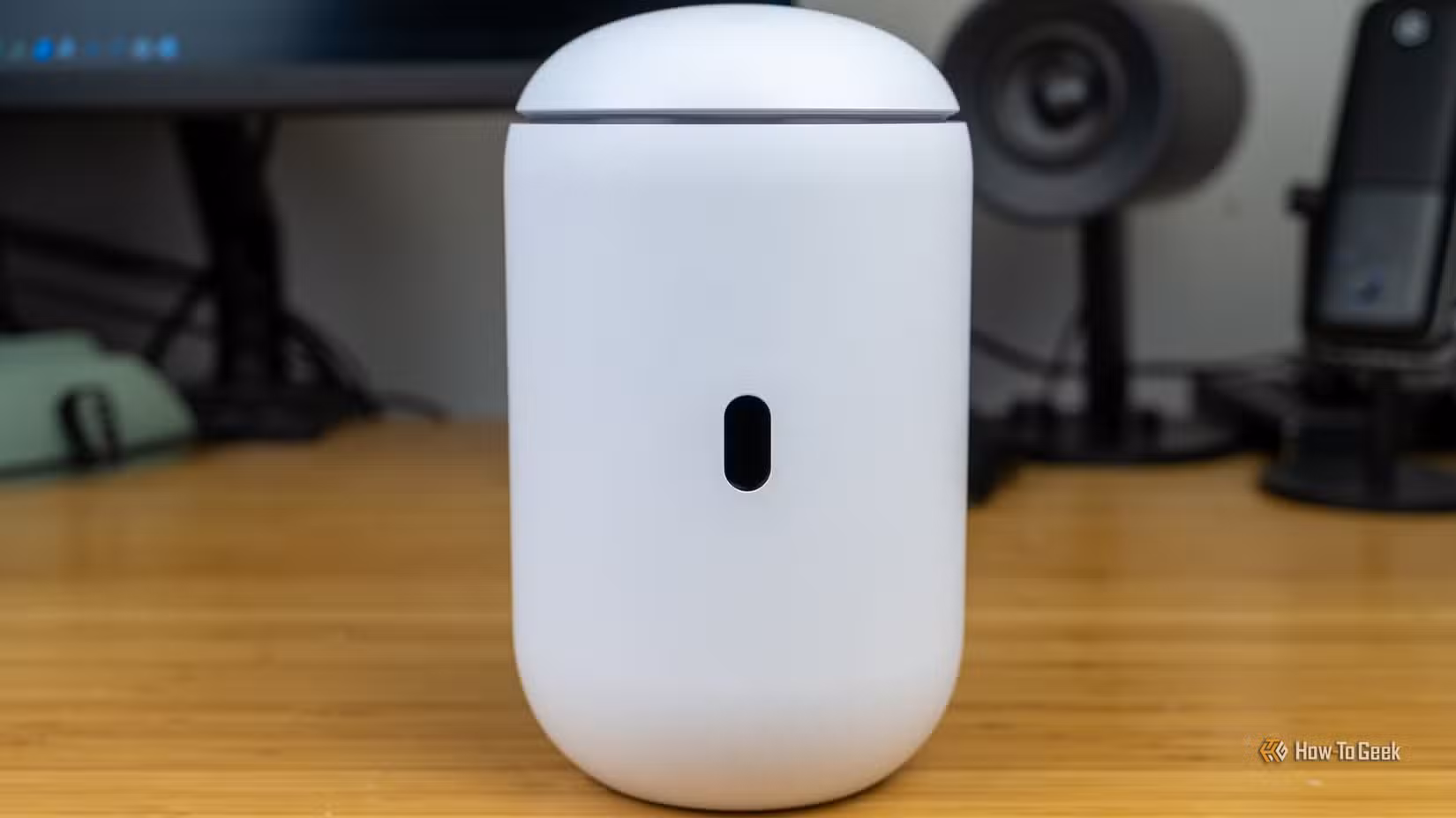 A front view of the Unifi Dream Router 7 with the screen visible but turned off.