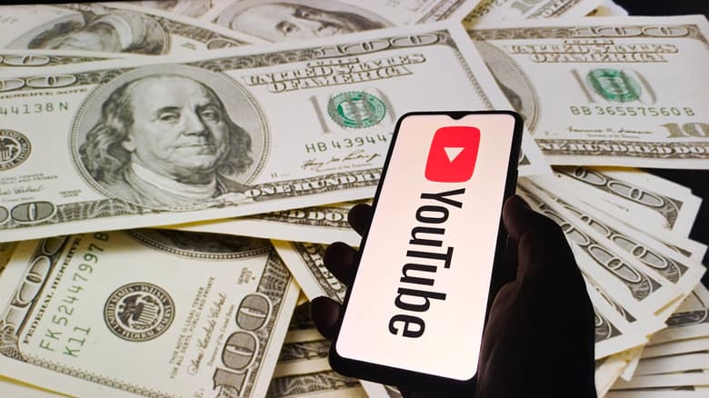 YouTube logo on phone with US currency in background