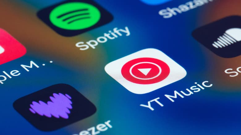 Close-up view of a smartphone screen displaying popular music streaming and audio applications