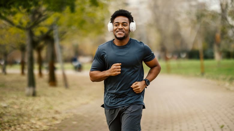 Man jogging in autumn weather with headphones on
