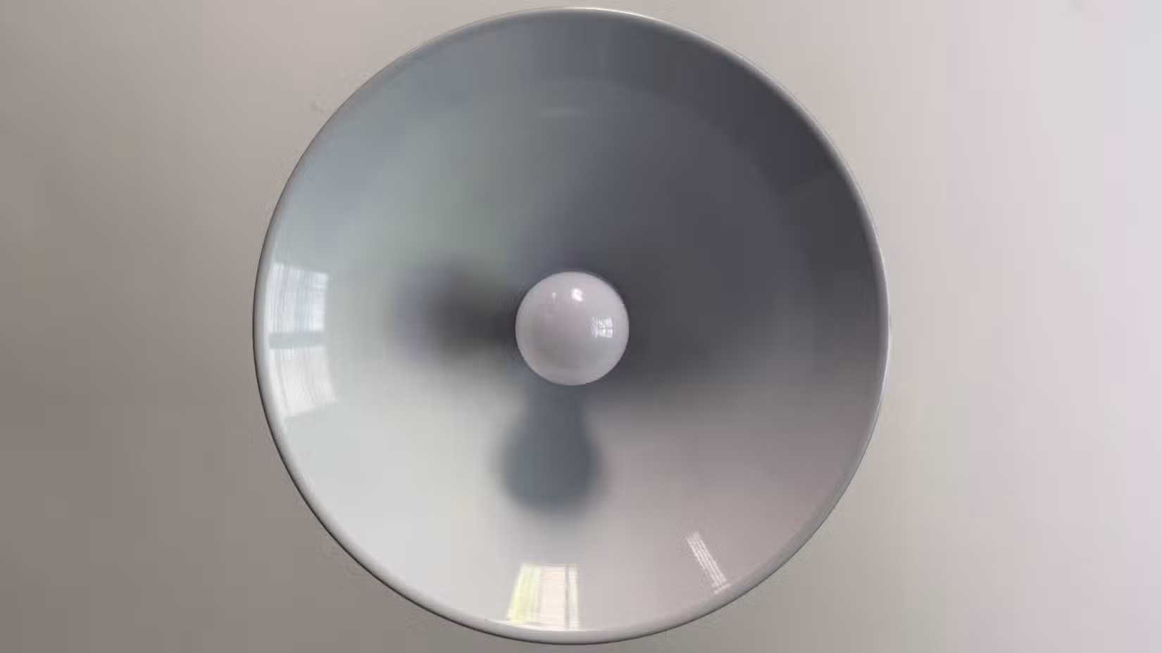 An IKEA smart bulb in a kitchen overhead light.