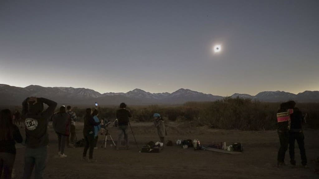 people gather to look at the total solar eclipse.