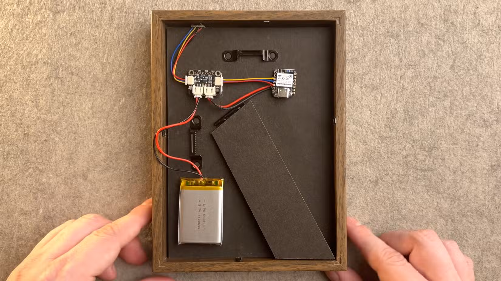 A temperature and humidity sensor hidden in an IKEA photo frame by Microamp Home on Youtube