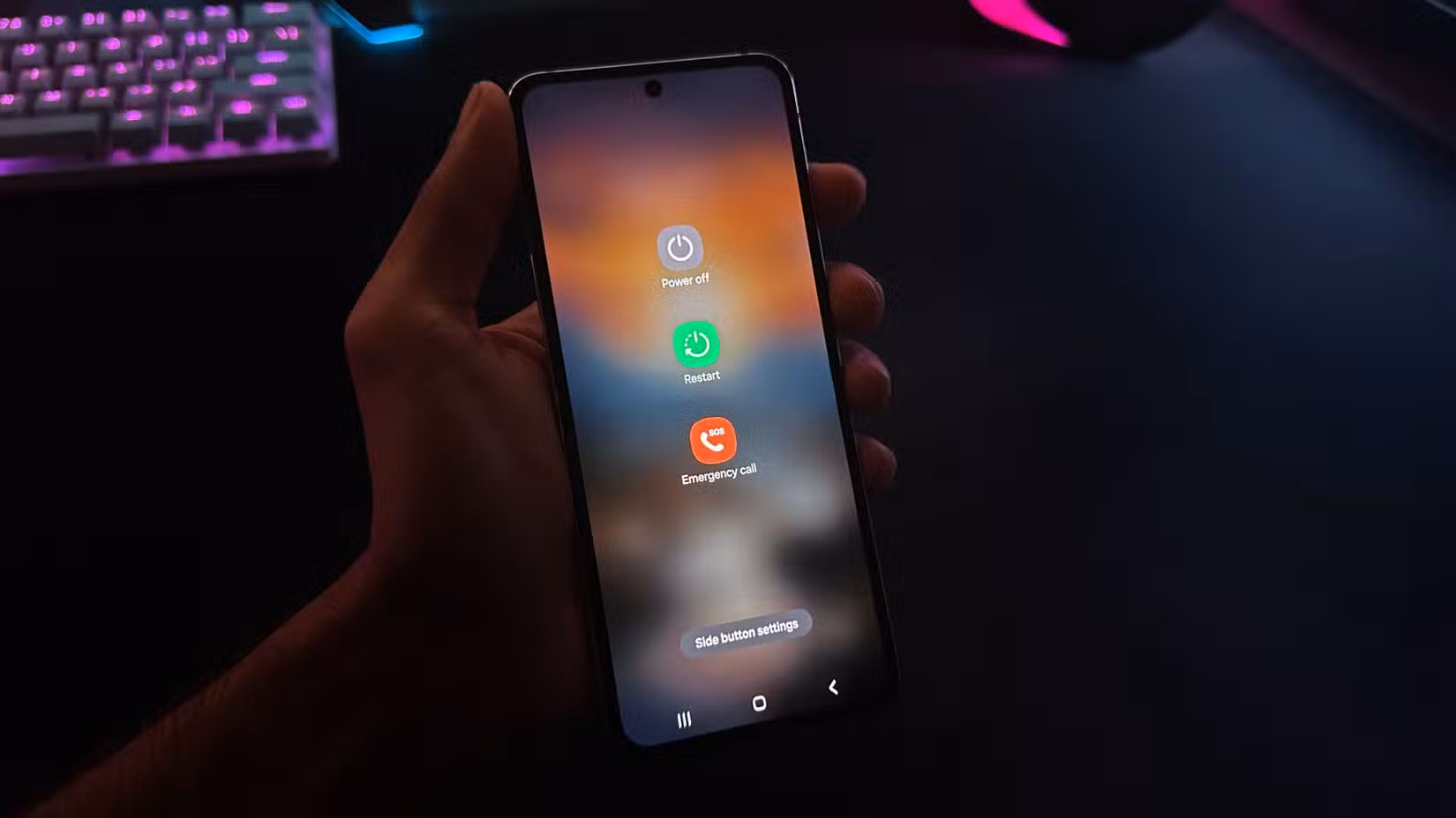 A person holding an Android phone in the hand with power off menu open on it.