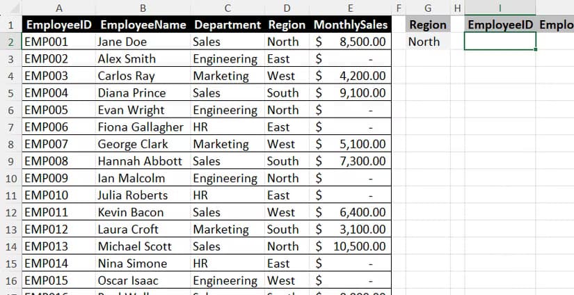 An Excel worksheet containing a data grid of employee records alongside a region cell and an empty destination cell for an output range.