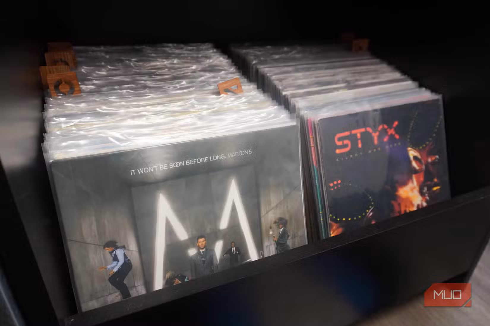 A collection of vinyl records in plastic sleeves.