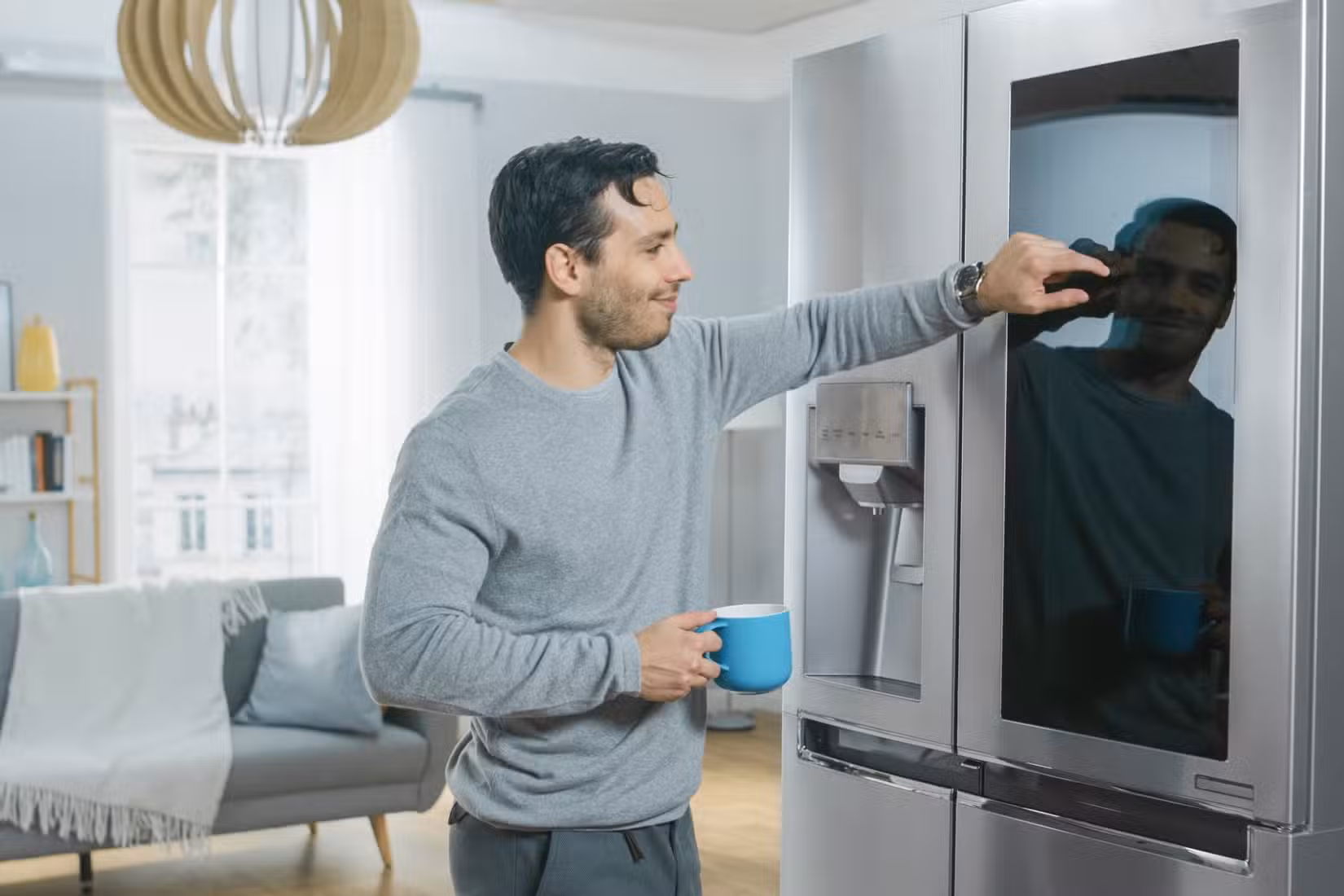 a man using a smart fridge screen