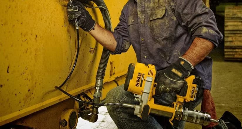 Person using the DeWALT grease gun