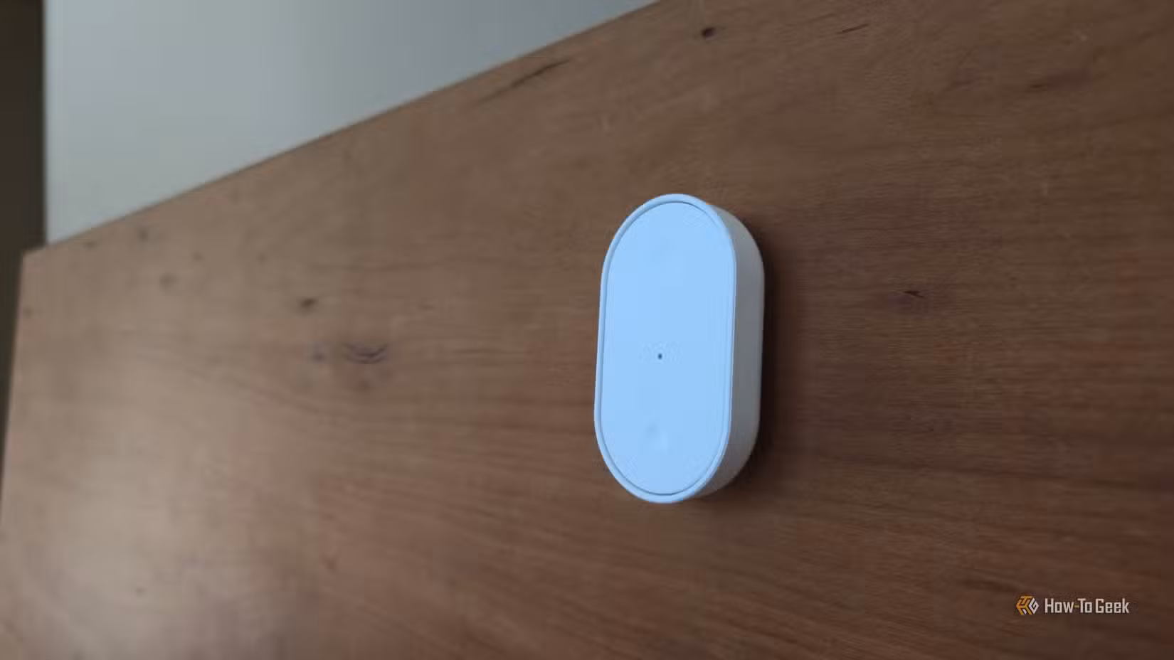 IKEA BILRESA dual button remote attached to a bed frame.