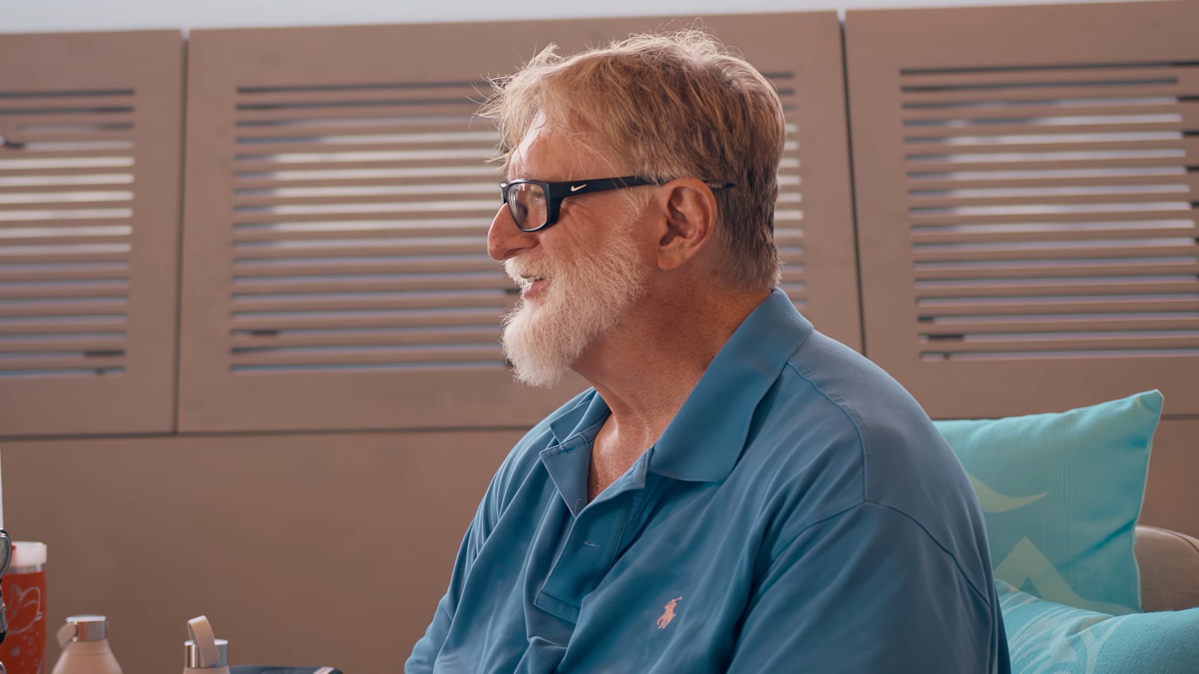 Extremely rich guy Gabe Newell smilng in profile, because he is an extremely rich guy doing extremely rich guy things
