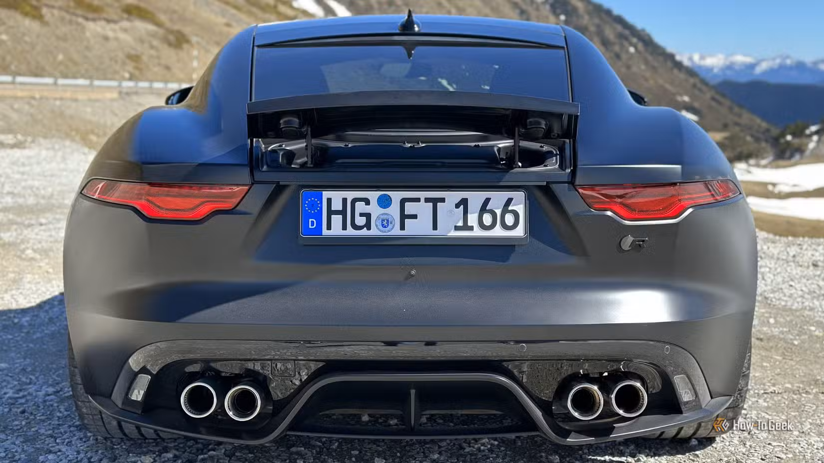 Static rear-end shot of a black 2023 Jaguar F-Type R 75.