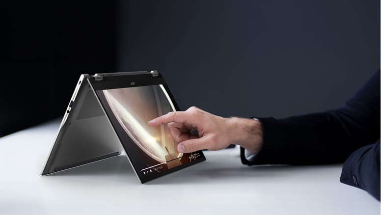 A person reaching out to touch the Swift Spin 14 AI (in tent mode)