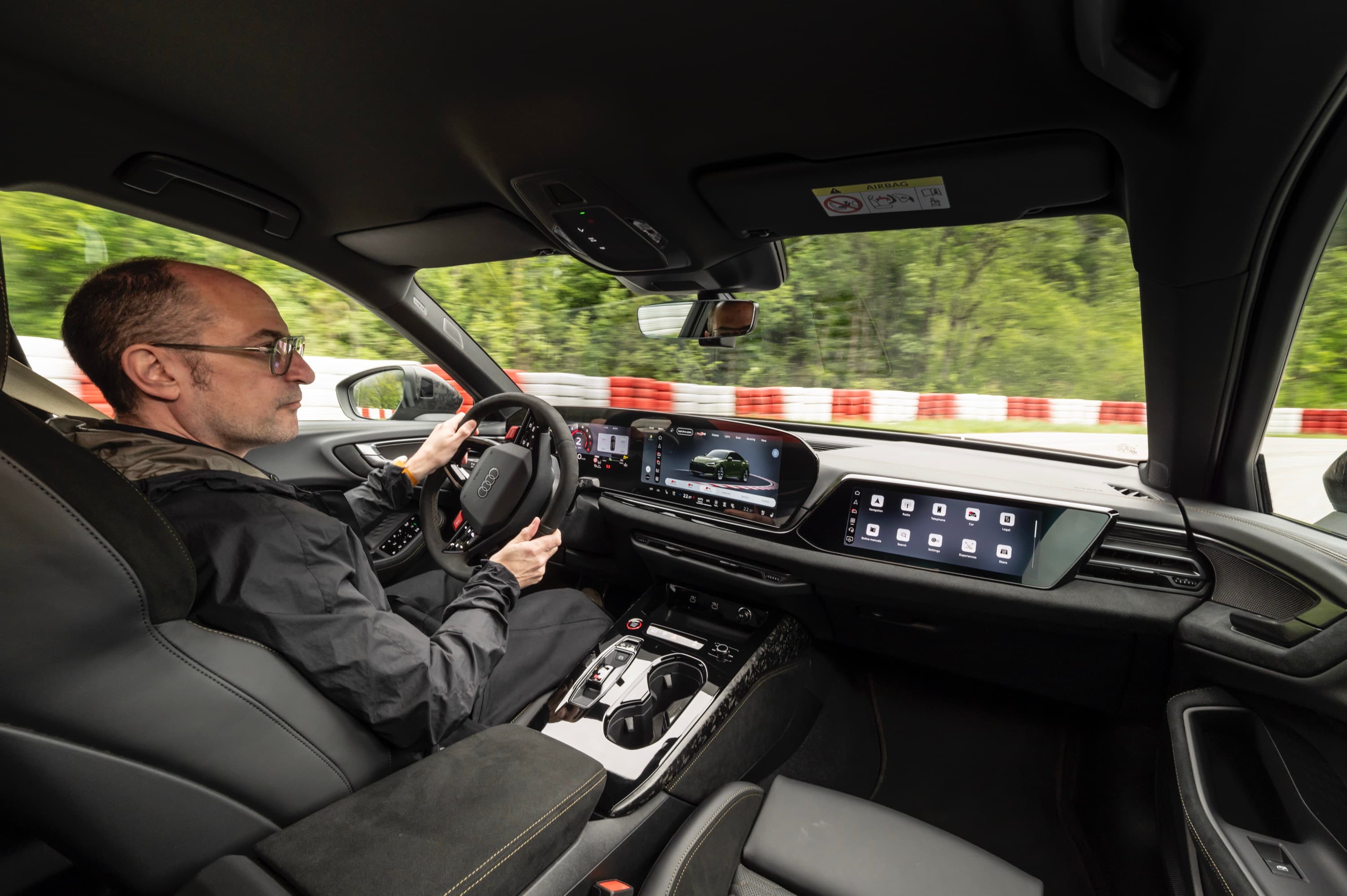 A man drives an Audi RS5 on track
