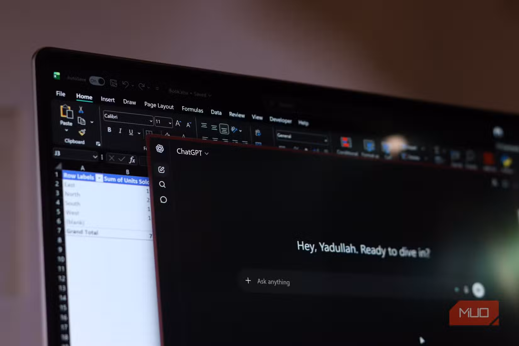 Excel and ChatGPT open on Windows 11 laptop.