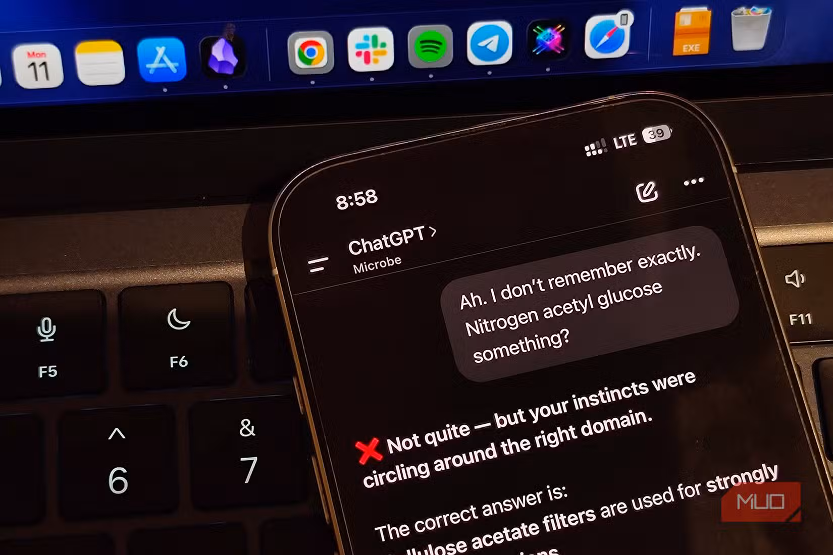 ChatGPT on iPhone put against a laptop keyboard