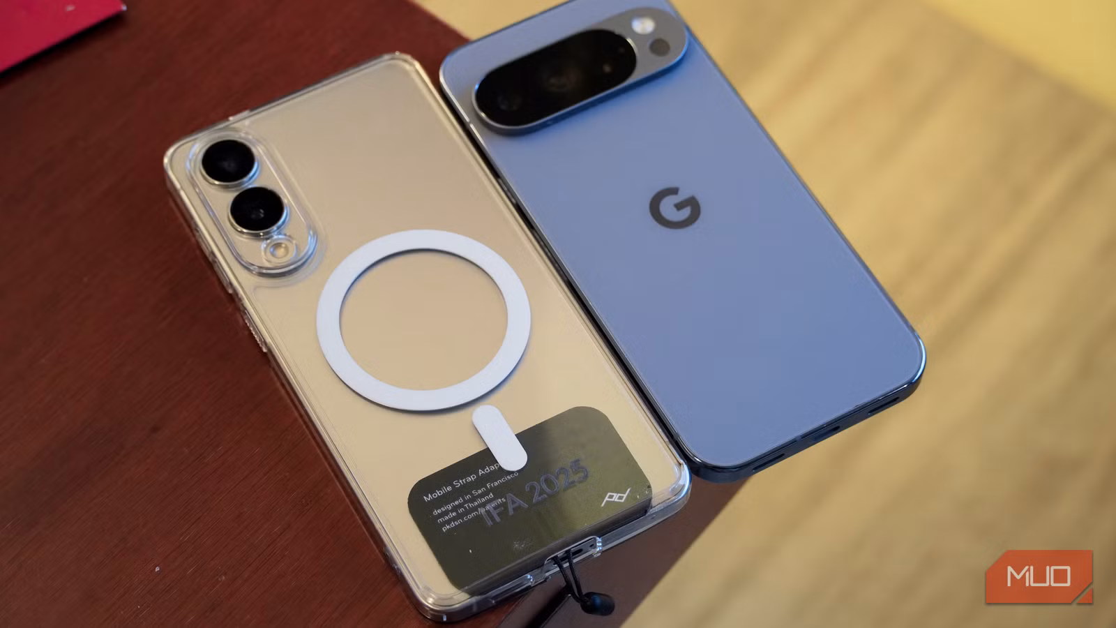 Qi2 with a case on a Galaxy phone next to a Pixel with Qi2 built-in.