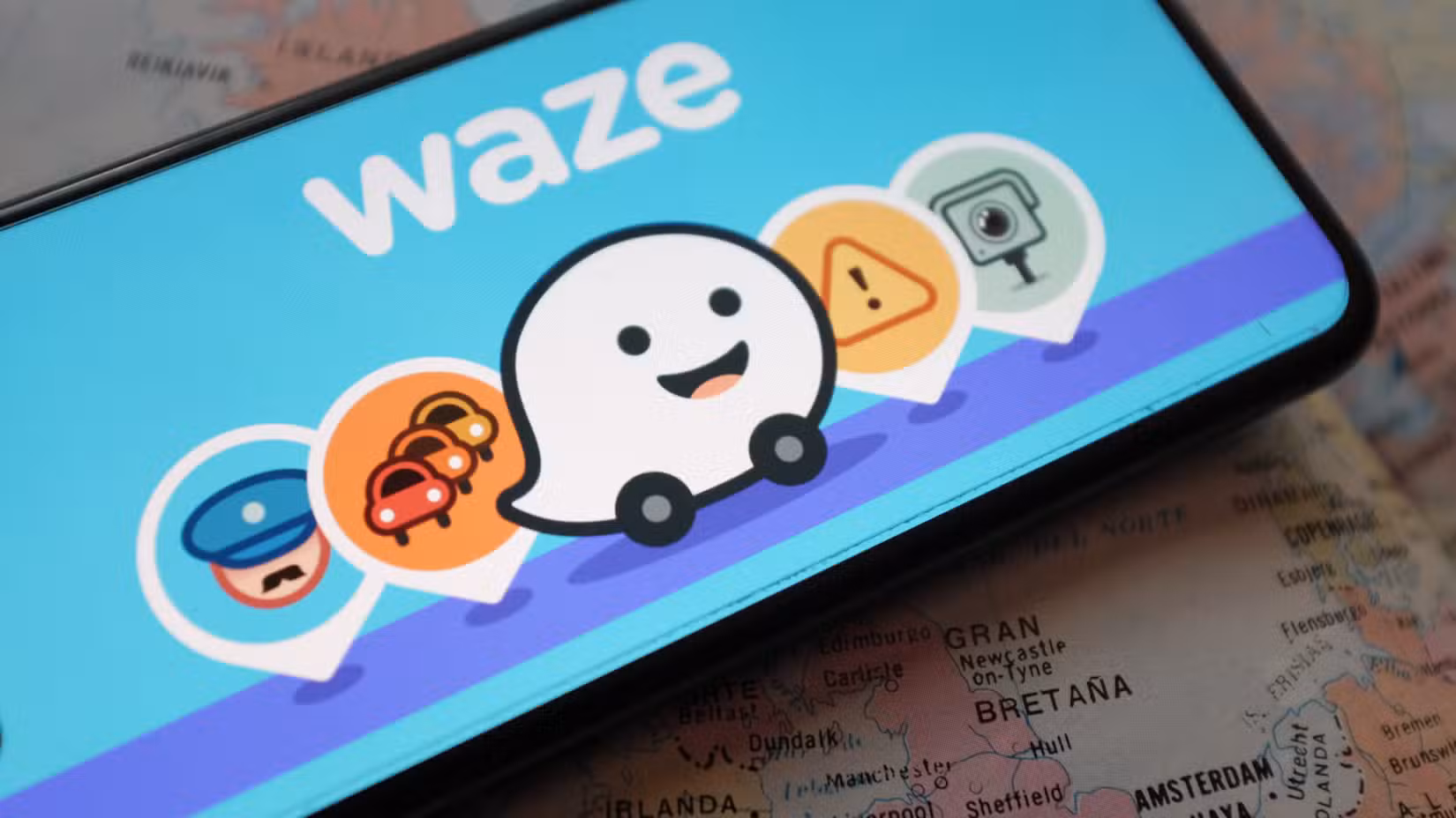 A smartphone showing the Waze app and icons on the screen.