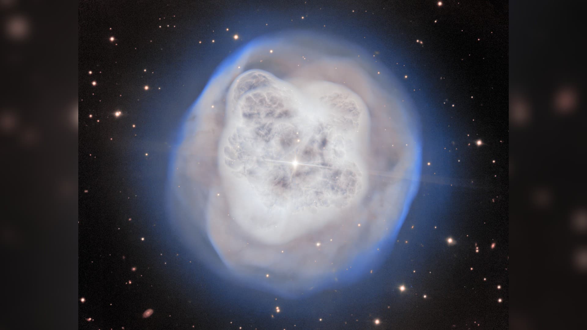 a white orb-shaped cloud of gas on a starry background