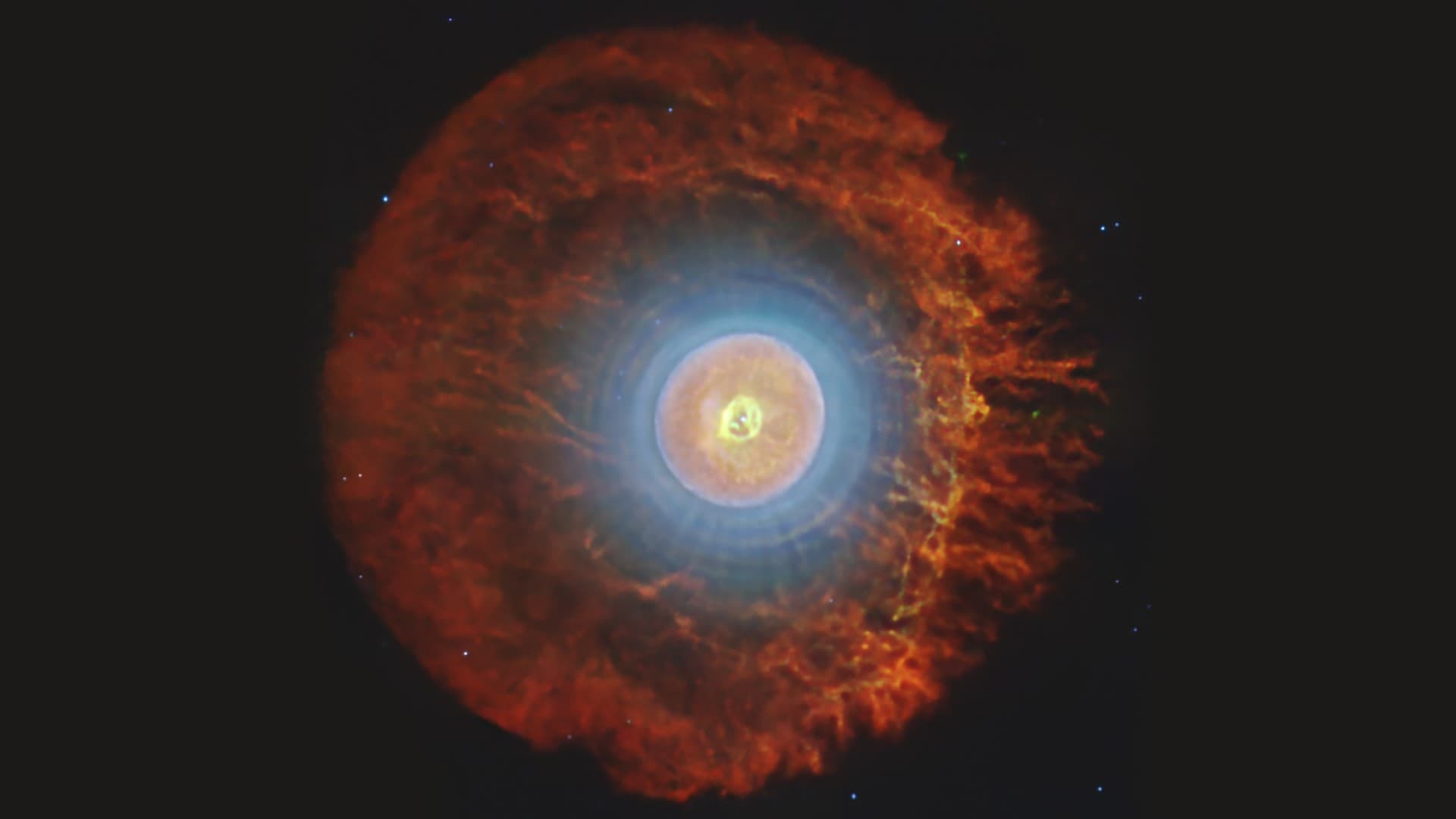 a cloud of blue, white with a ring of red light around it on a black background