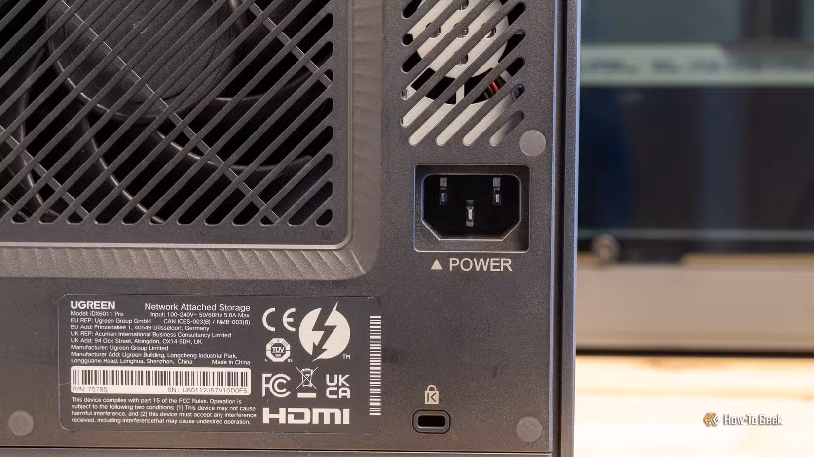 The back of the Ugreen iDX6011 Pro NAS showing the exhaust fans, power inlet, and product label.