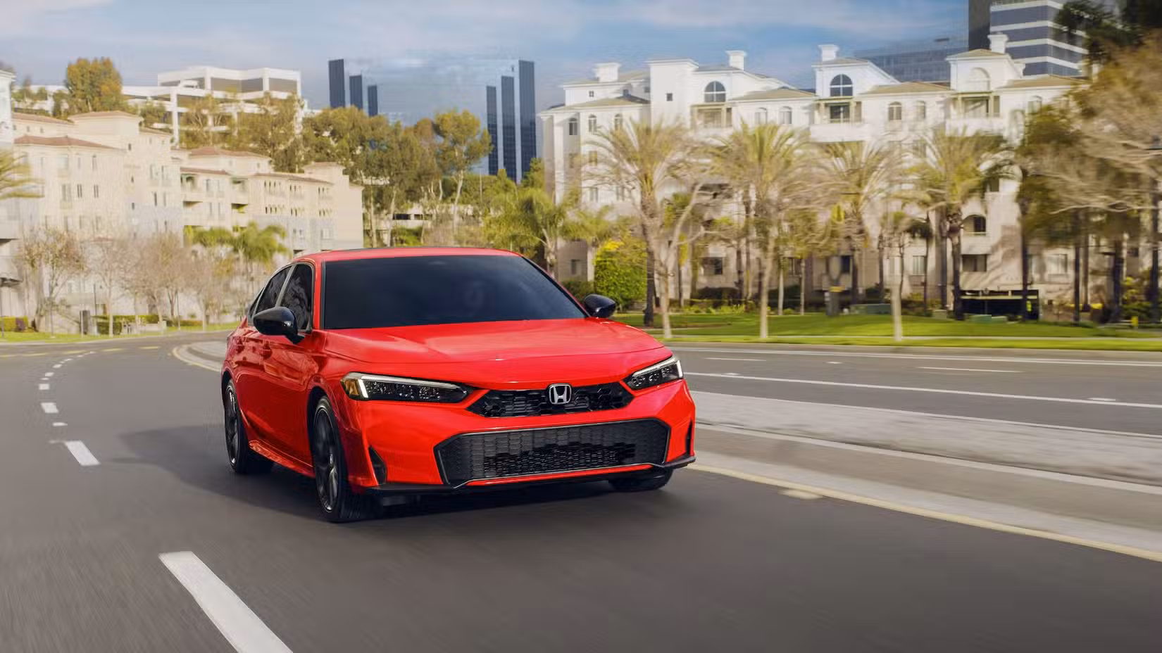 Dynamic front 3/4 shot of a red 2026 Honda Civic Sedan Sport Hybrid driving in a city.