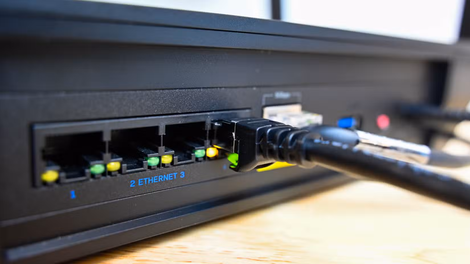 Ethernet cable plugged into an ethernet port on a router.
