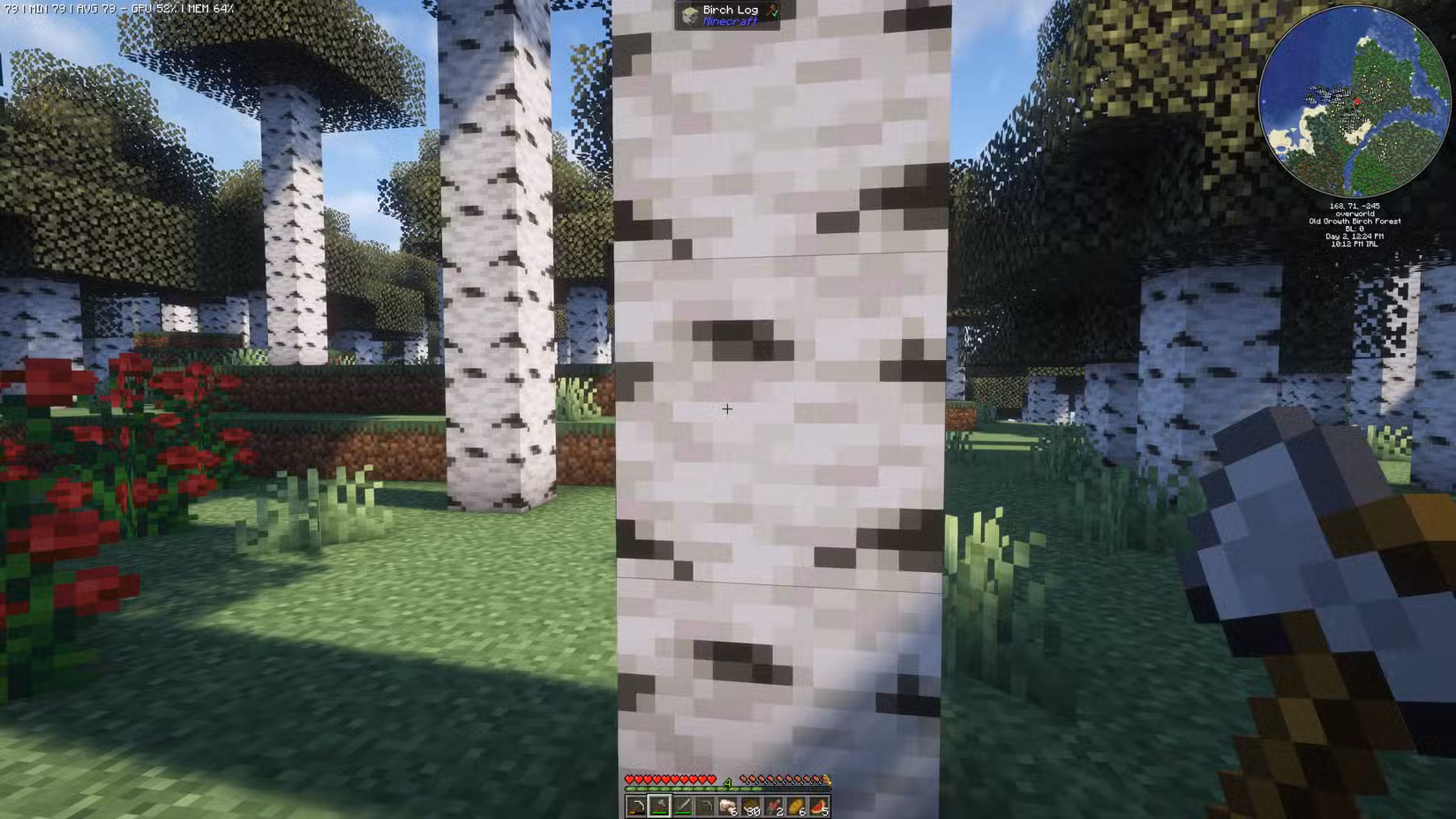 A birch tree in Minecraft with an axe in hand ready to cut it down.