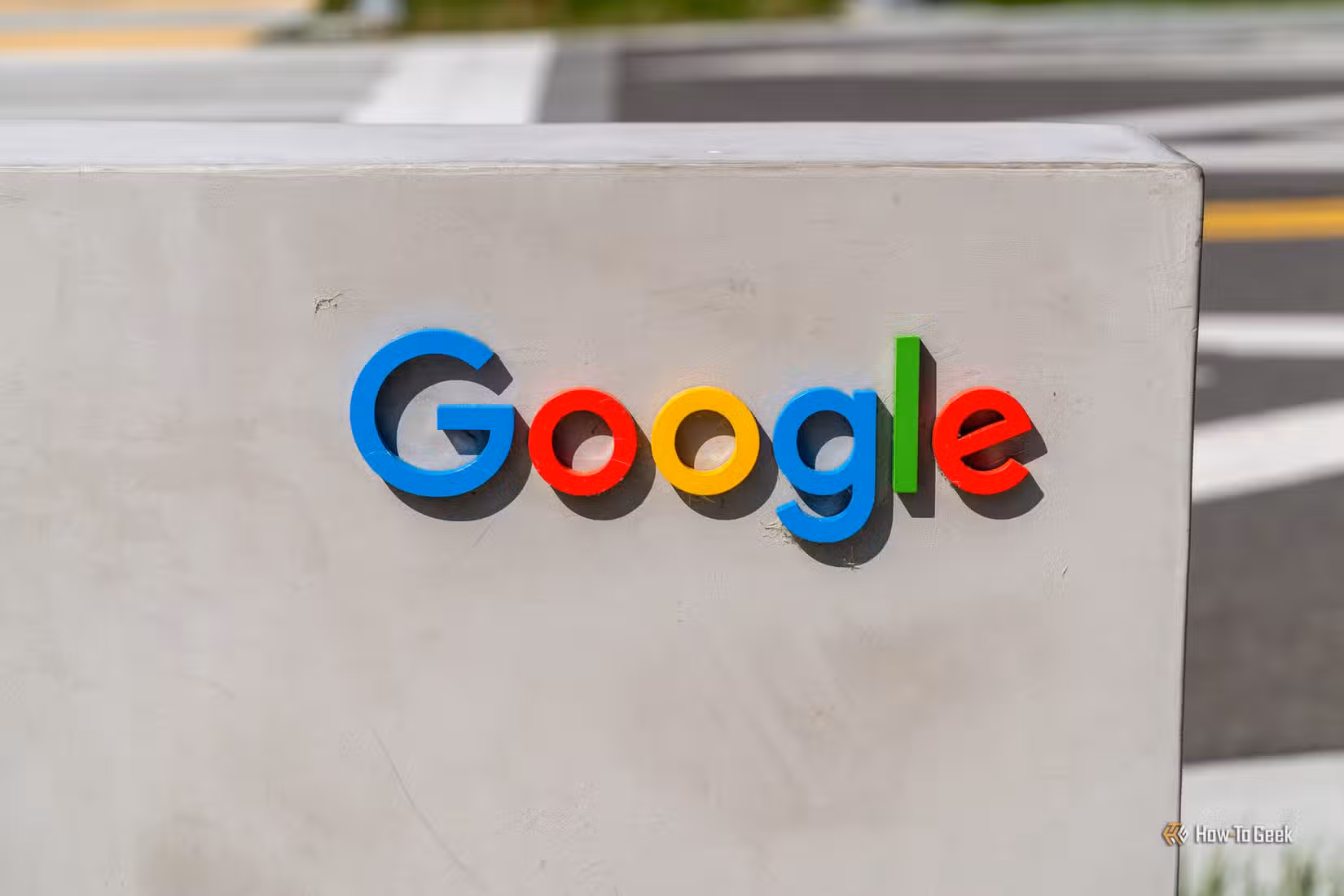 The colorful Google logo mounted on a concrete sign outdoors.