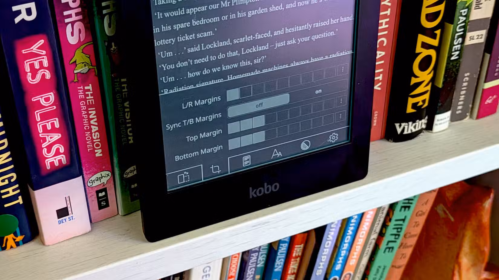 Kobo Aura HD on a book shelf 2