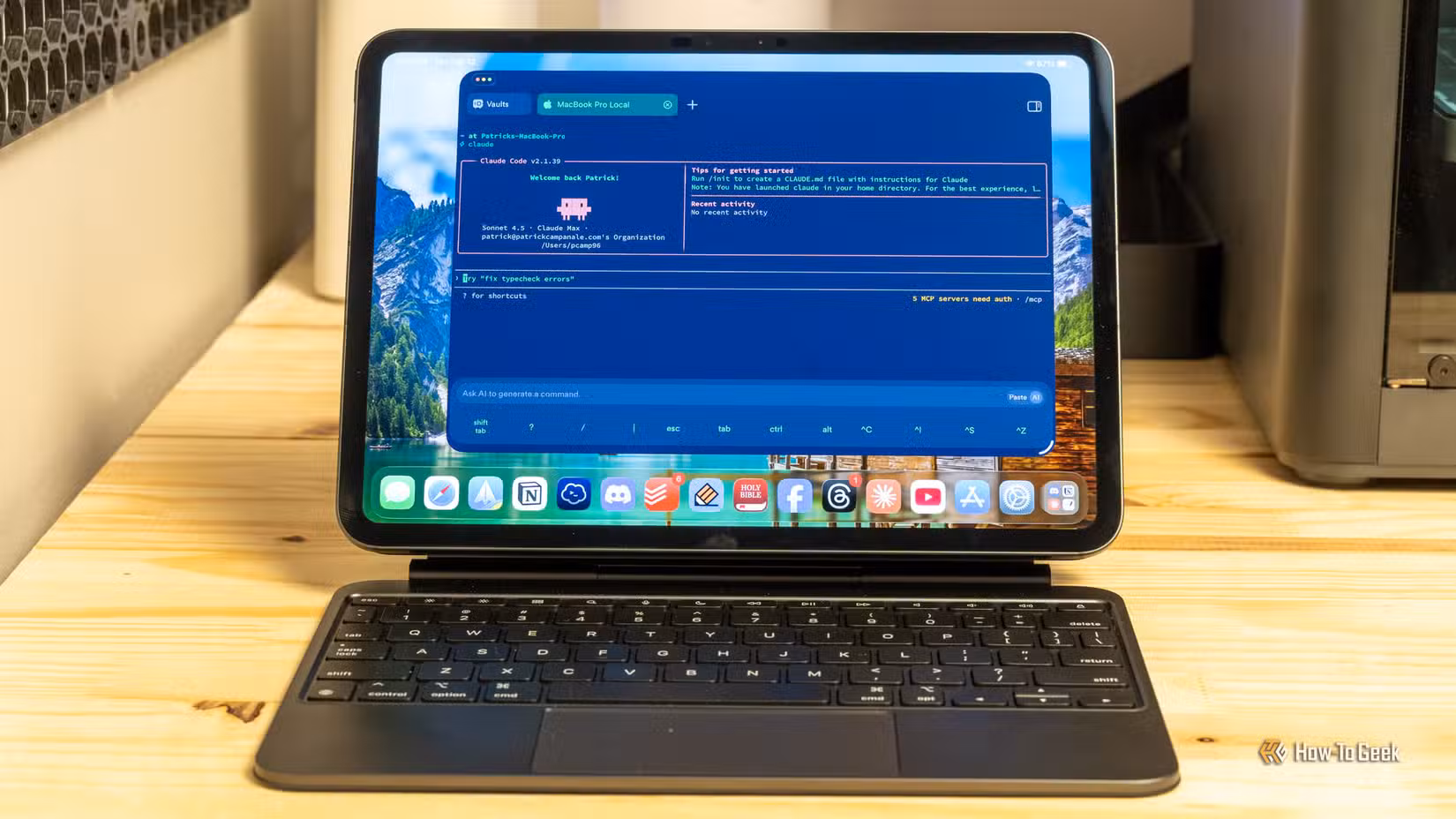 Claude Code terminal running on an iPad with a keyboard case on a wooden desk.