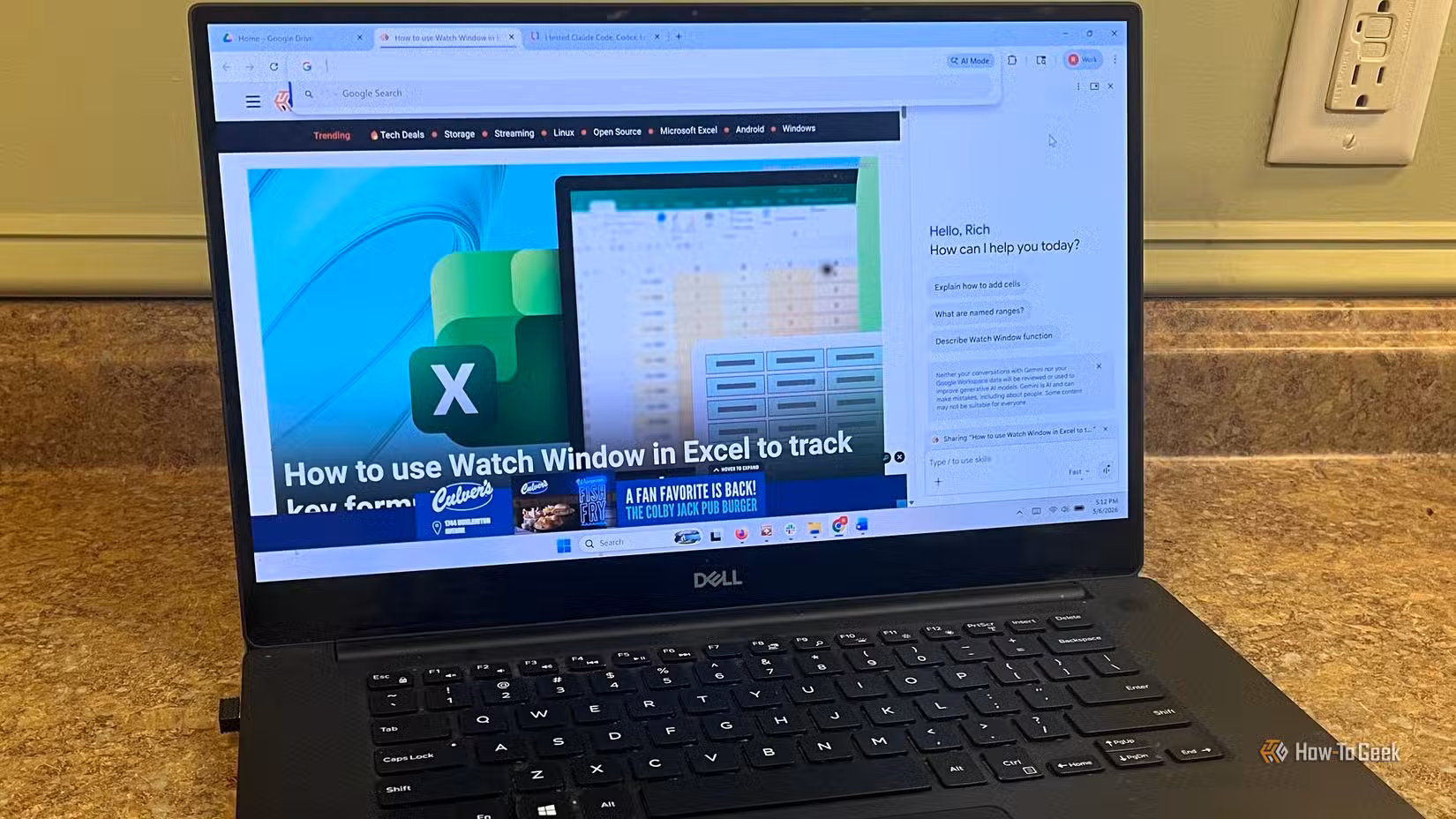 An image of a laptop on a countertop with Google Chrome open. In Chrome the Gemini sidebar is loaded and open.