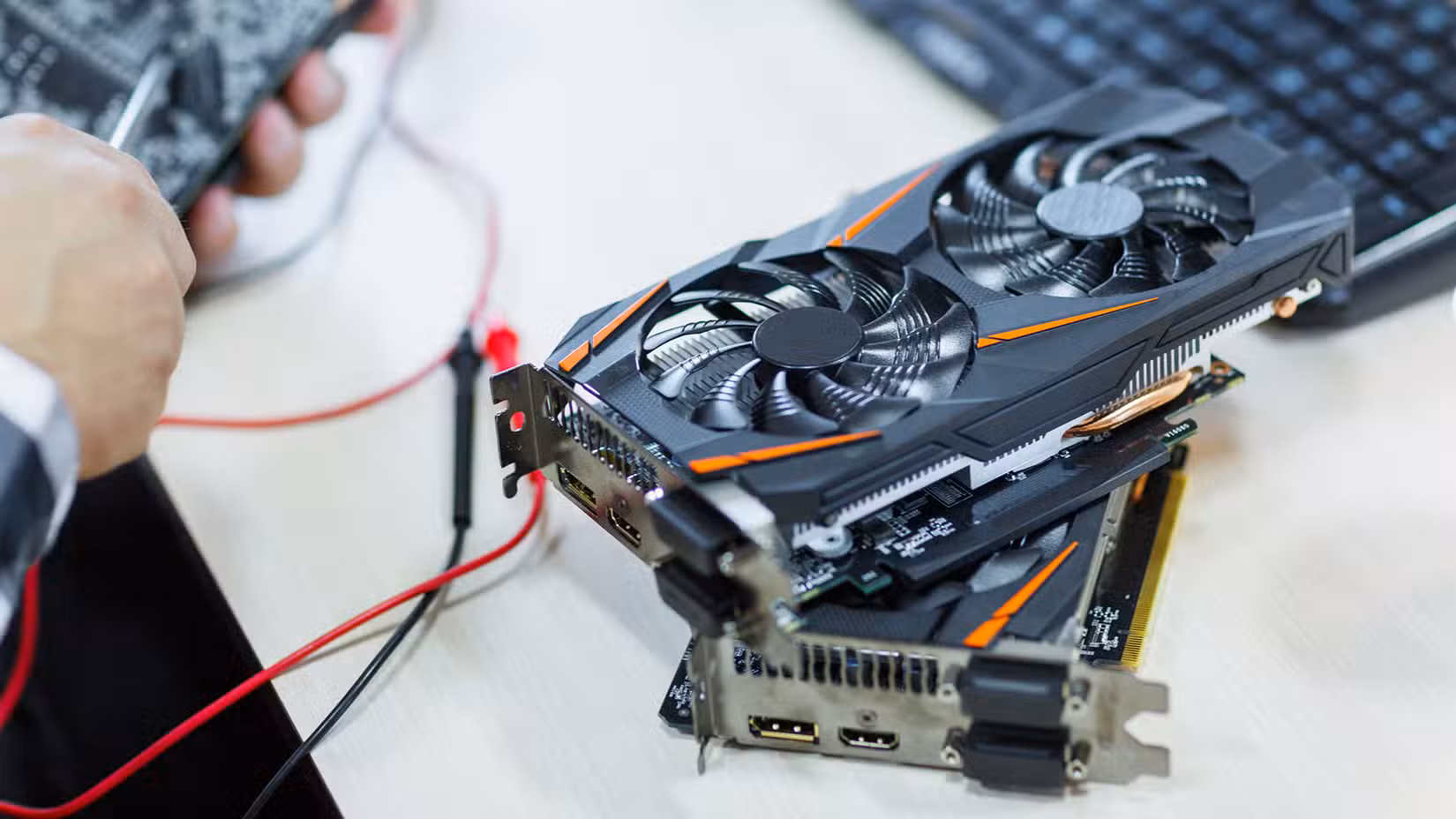 A photo of two graphics cards stacked on top of one another for testing.
