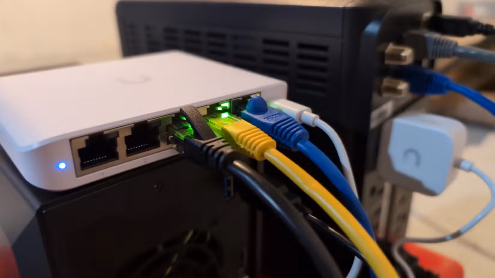 Ethernet cables plugged into a Ubiquiti Flex Mini managed network switch.