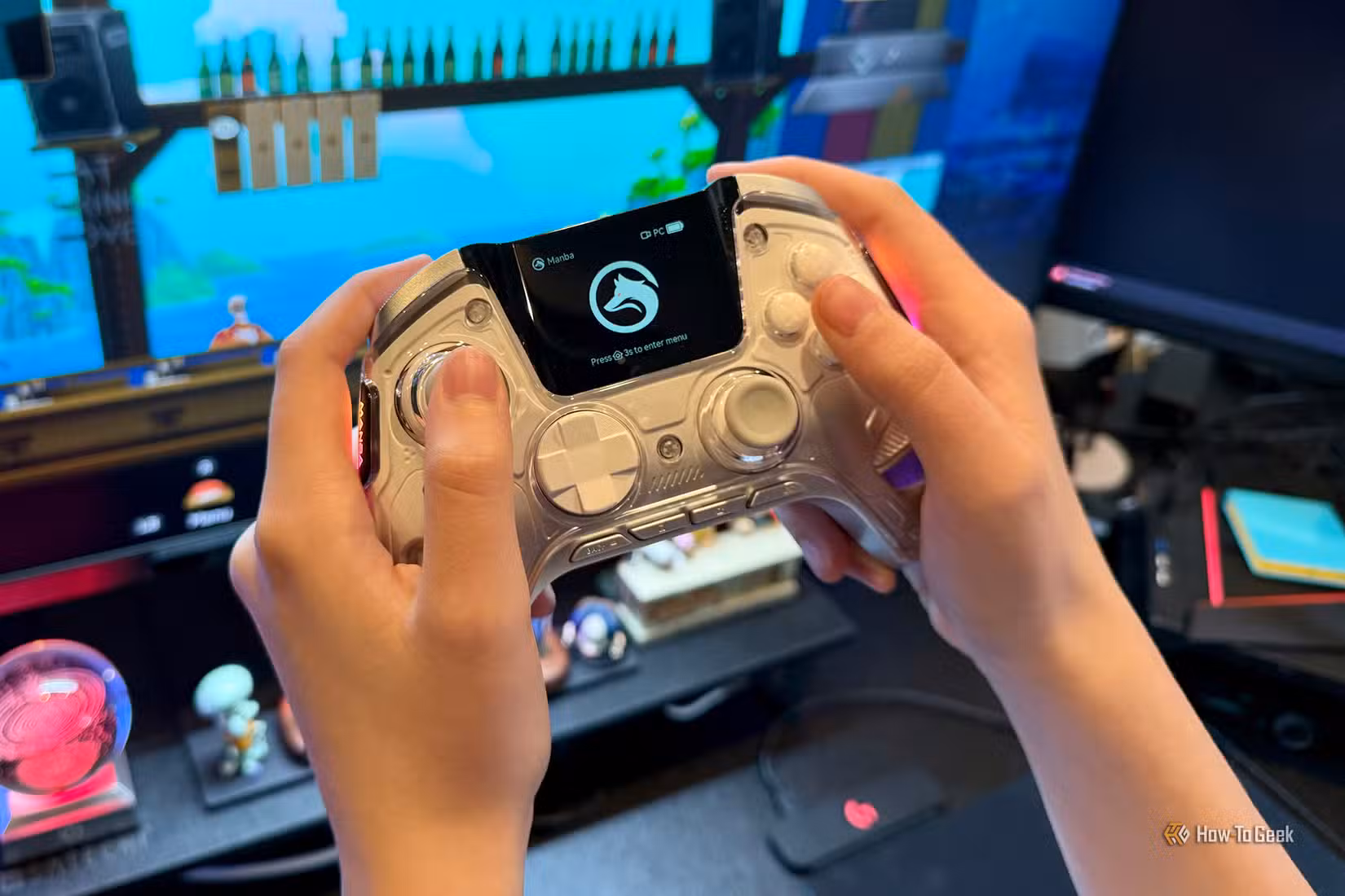 Manba One Game Controller being held in front of a computer screen