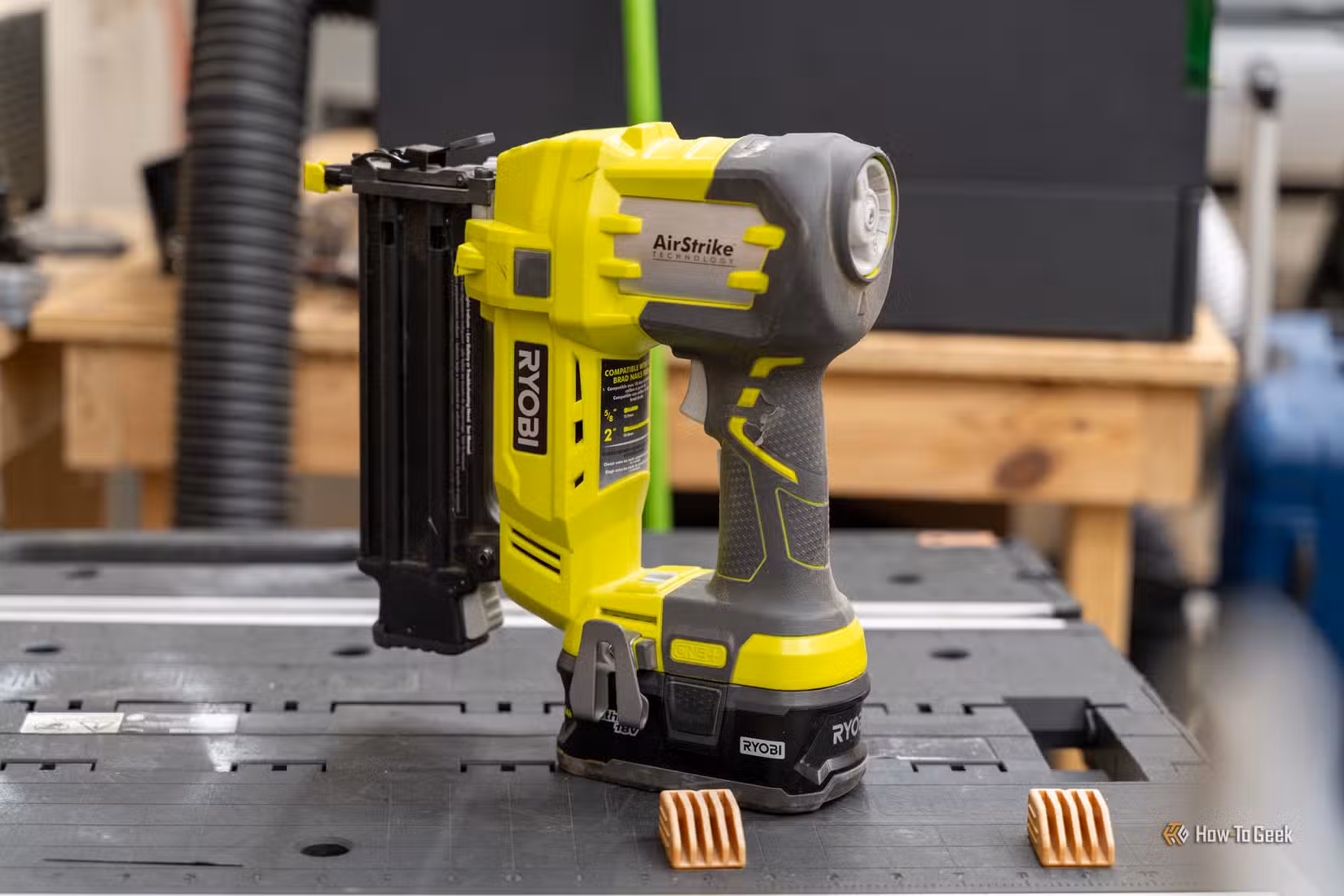 Ryobi AirStrike cordless brad nailer standing on a portable workbench.