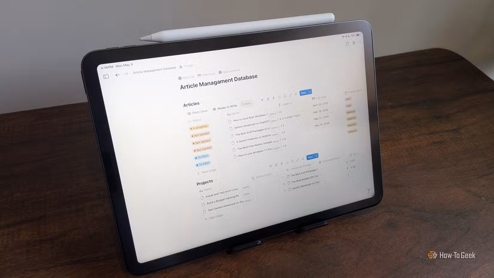 Article Management Database open in Notion on an iPad Air with Apple Pencil resting on top.-1