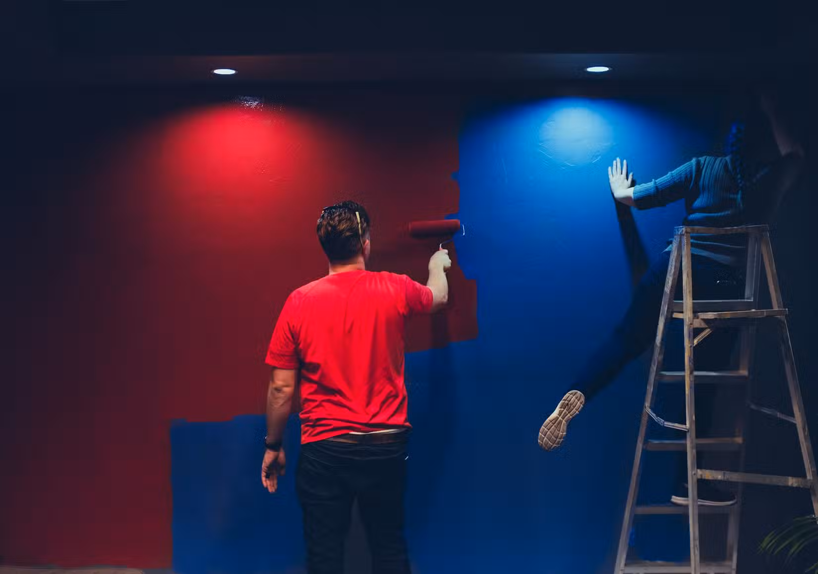 People painting a wall.