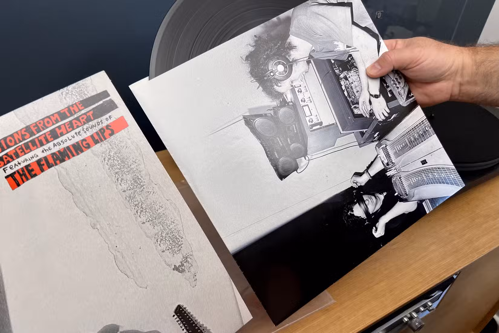 Pulling a vinyl record out of its sleeve